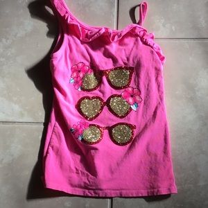 A pink shirt white sunglasses